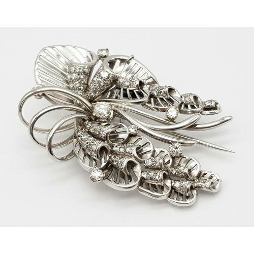 899 - A Platinum and Diamond Brooch. A beautiful coastal themed piece with diamond encrusted shells amongs... 