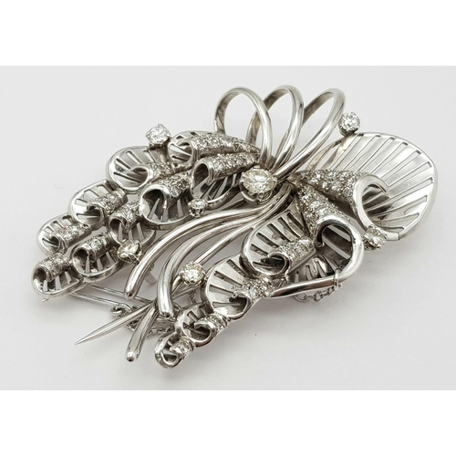 899 - A Platinum and Diamond Brooch. A beautiful coastal themed piece with diamond encrusted shells amongs... 