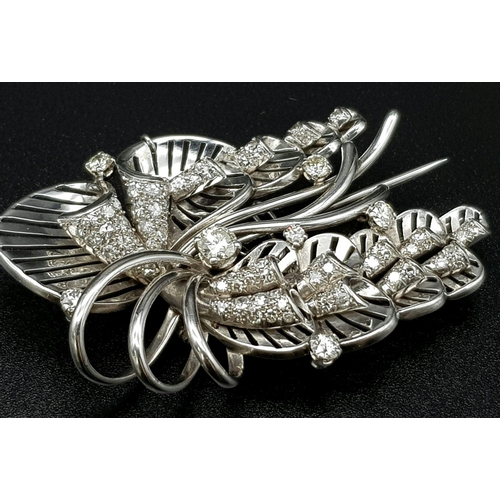 899 - A Platinum and Diamond Brooch. A beautiful coastal themed piece with diamond encrusted shells amongs... 