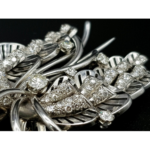 899 - A Platinum and Diamond Brooch. A beautiful coastal themed piece with diamond encrusted shells amongs... 