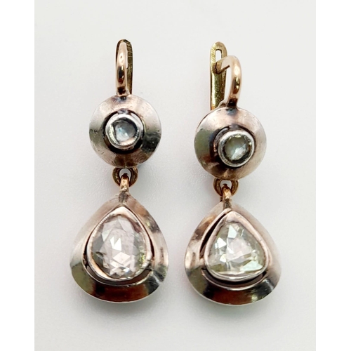 583 - A Pair of 18K Gold and Platinum Diamond Drop Earrings.
2.5cm drop. 5.6g total weight