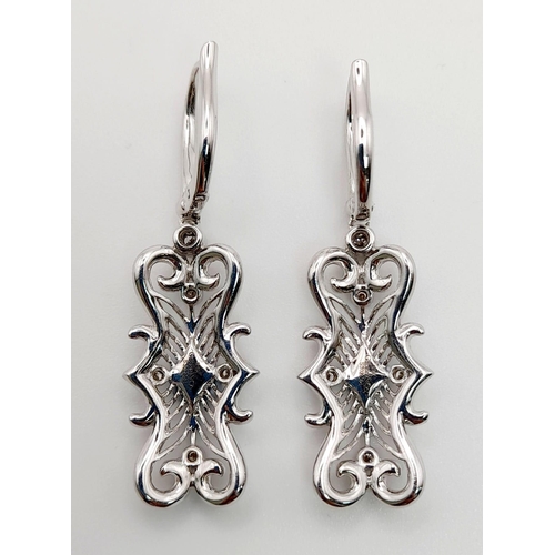 454 - A Pair of 18K White Gold and Diamond Art Deco Style Drop Earrings. Beautiful filigree and piercing w... 