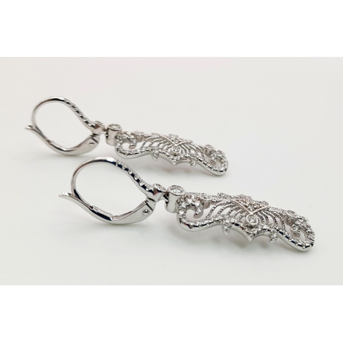 454 - A Pair of 18K White Gold and Diamond Art Deco Style Drop Earrings. Beautiful filigree and piercing w... 