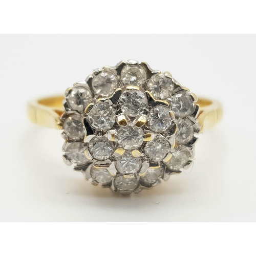 592 - An 18K Yellow Gold Diamond Cluster Ring. Floral shape - 1.0ct. H-VS Grade. Size P. 3.7g.