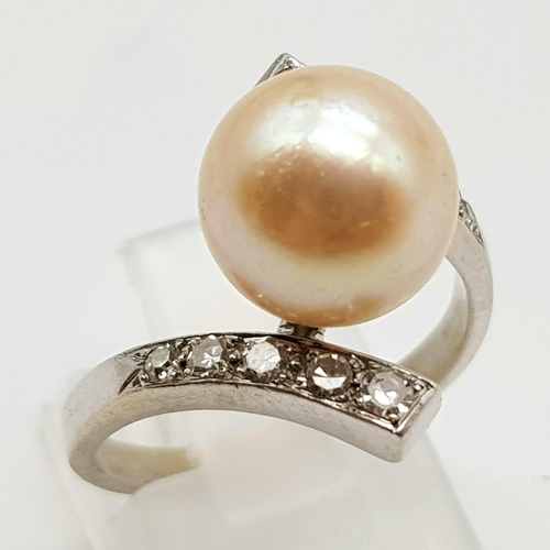 599 - An 18K White Gold Diamond and Natural Pearl Ring. 
Size N. 5.2g.