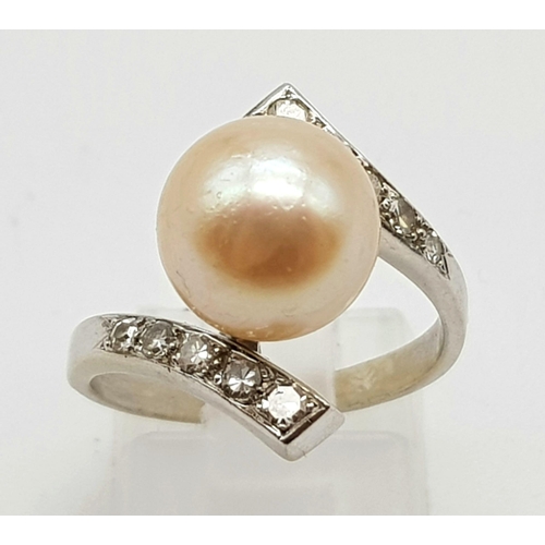 599 - An 18K White Gold Diamond and Natural Pearl Ring. 
Size N. 5.2g.