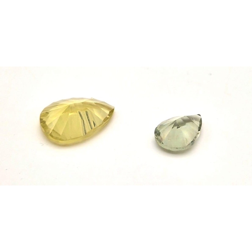 593 - Lot of 2 Gemstones - 10.85ct  Mixed Concave Cut Lemon Quartz and a 4.95ct Mixed Concave Cut Green Am... 