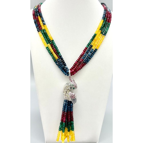 505 - A fabulous four strand necklace with rubies, emeralds, sapphires, citrine and a glorious exotic parr... 