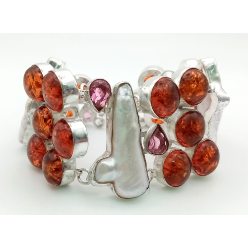 584 - A very unusual silver bracelet with a combination of numerous amber cabochons and large Biwa natural... 