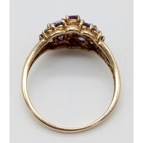 428 - A 9K Yellow Gold Amethyst and White Stone Cluster Ring.
Size P. 2.43g total weight.