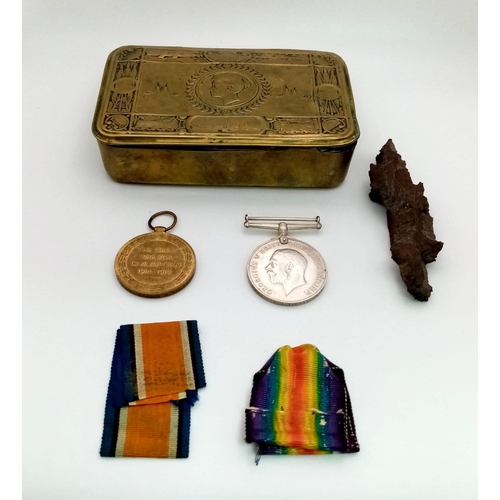 486 - WW1 British Medal Duo and a piece of shell shrapnel in a Princess Mary Xmas Tin. Awarded To: 43607
P... 