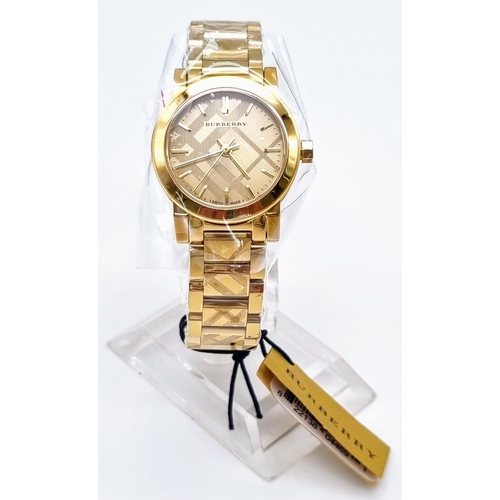 126 - A rare and beautiful, BURBERRY, THE CITY, ladies watch with engraved check bracelet. 27mm case, Sapp... 