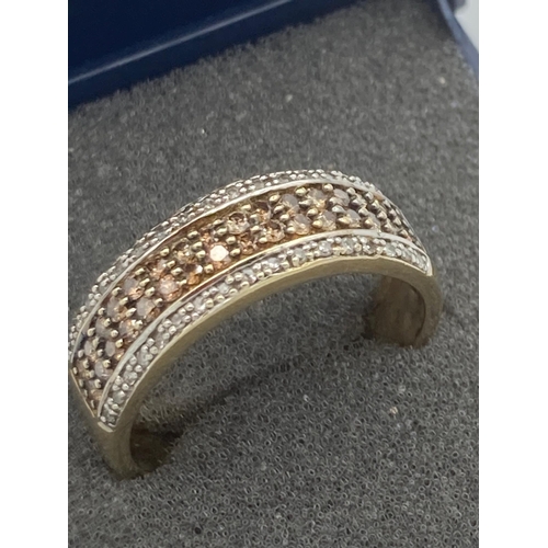 14 - 9k GOLD and DIAMOND RING having four rows of CHAMPAGNE and WHITE DIAMONDS in half eternity style. 3.... 