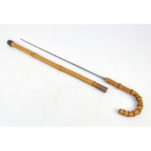 122 - An Antique Bamboo walking Stick/Cane with Hidden Sword. Markings on blade for Leon. 85cm total lengt... 