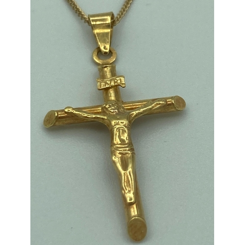 148 - 9 carat GOLD CRUCIFIX and CHAIN. Gold chain 45 cm. Gold Crucifix 3 cm drop.  1.65 grams.