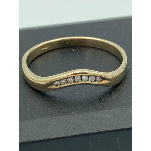 176 - 9k GOLD and DIAMOND wave ring in semi wishbone shape and Channel set with DIAMONDS. 1.97 grams Size ... 