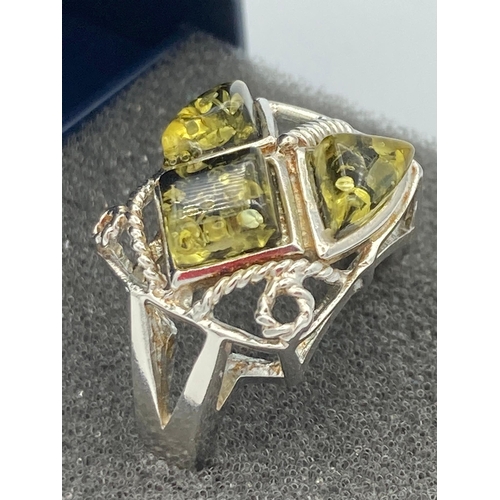 525 - SILVER & AMBER RING in modernist design having openwork shoulders and  set with 3 pieces of LIME AMB... 