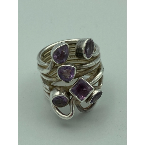 532 - SILVER and AMETHYST RING having wide SILVER coiled band set to top with Amethysts. Presented in jewe... 