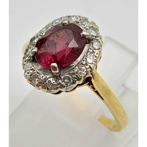 337 - A Vintage 18K Yellow Gold Ruby and Diamond Ring. Central oval ruby surrounded by a halo of diamonds ... 