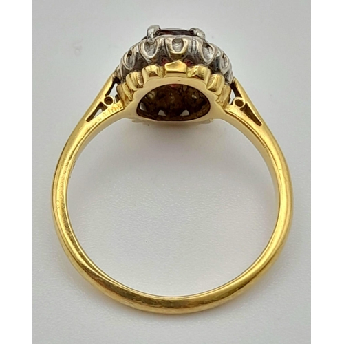 337 - A Vintage 18K Yellow Gold Ruby and Diamond Ring. Central oval ruby surrounded by a halo of diamonds ... 