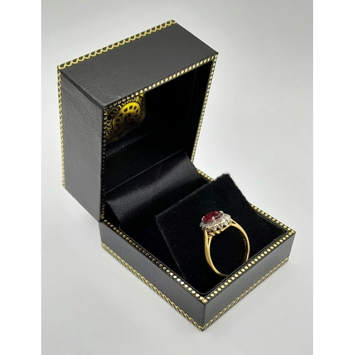 337 - A Vintage 18K Yellow Gold Ruby and Diamond Ring. Central oval ruby surrounded by a halo of diamonds ... 