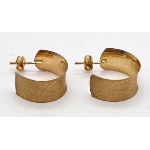 604 - 9k yellow gold 9mm wide engraved hoop earrings.
Weighs 2.44g