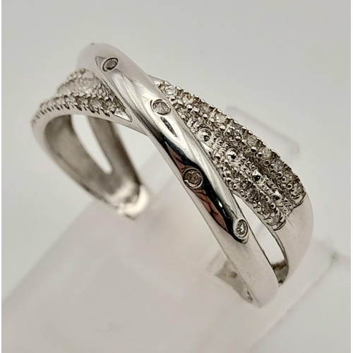 416 - 9k white gold diamond crossover ring 
Size Q, weighs 2.55g (0.36ct diamonds)