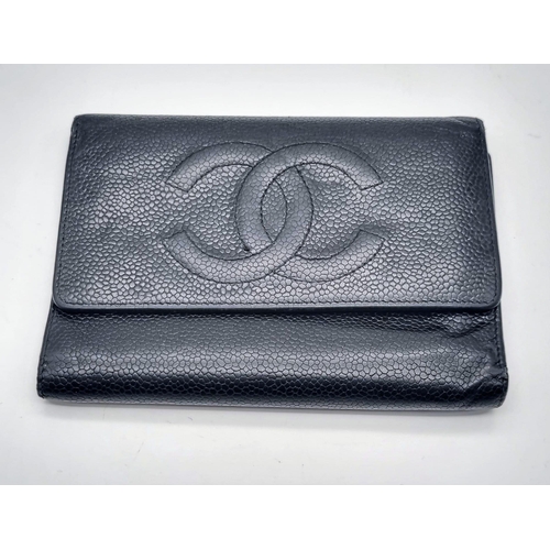 186 - A Classic Vintage Chanel Black Leather Wallet with Authentication Card. Chanel motif on front. Zippe... 