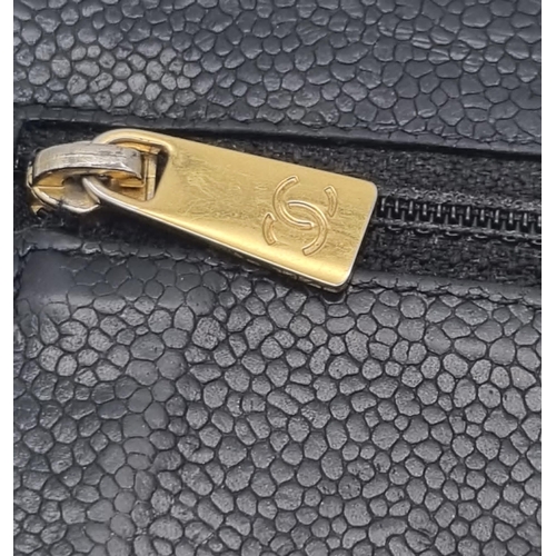 186 - A Classic Vintage Chanel Black Leather Wallet with Authentication Card. Chanel motif on front. Zippe... 