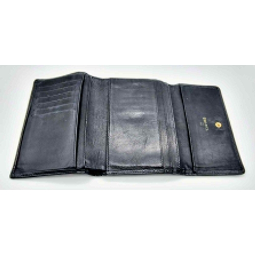 186 - A Classic Vintage Chanel Black Leather Wallet with Authentication Card. Chanel motif on front. Zippe... 