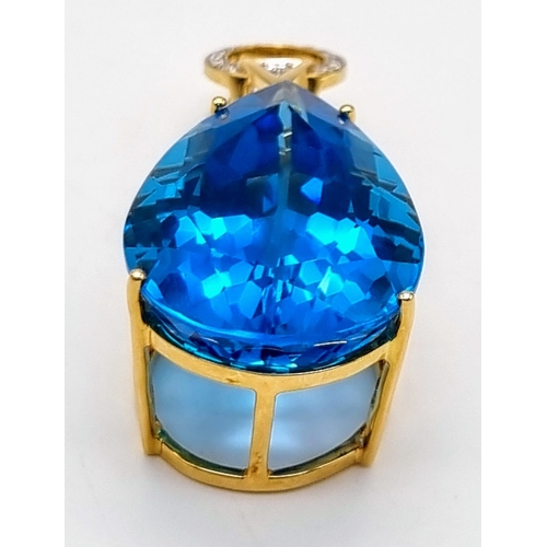 198 - An 18K Yellow Gold, Diamond and Mesmerizing Large Brazilian Blue 50ct Plus Topaz Pendant. 5cm length... 