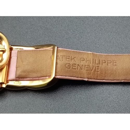 59 - A Patek Phillipe Gold and Diamond Ellipse Ladies Watch. Pink leather strap and gold buckle. Oval gol... 