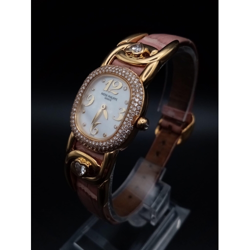 59 - A Patek Phillipe Gold and Diamond Ellipse Ladies Watch. Pink leather strap and gold buckle. Oval gol... 