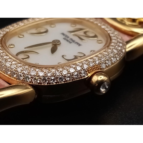 59 - A Patek Phillipe Gold and Diamond Ellipse Ladies Watch. Pink leather strap and gold buckle. Oval gol... 