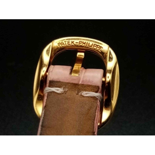 59 - A Patek Phillipe Gold and Diamond Ellipse Ladies Watch. Pink leather strap and gold buckle. Oval gol... 