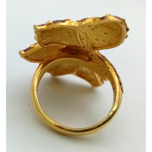 119 - A naturalistic Sterling Silver and 18K Yellow Gold ring in the shape of an ivy leaf. A central facet... 