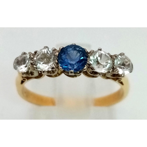 289 - An 18k Yellow Gold Central Round Cut Sapphire and Four Clear Stone Ring Size N. 4mm Sapphire and 3-3... 