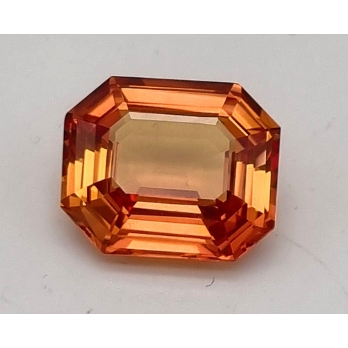 133 - A high Quality, Large 16.41ct Orange Sapphire. Rectangular step cut, excellent, vivid and uniform co... 