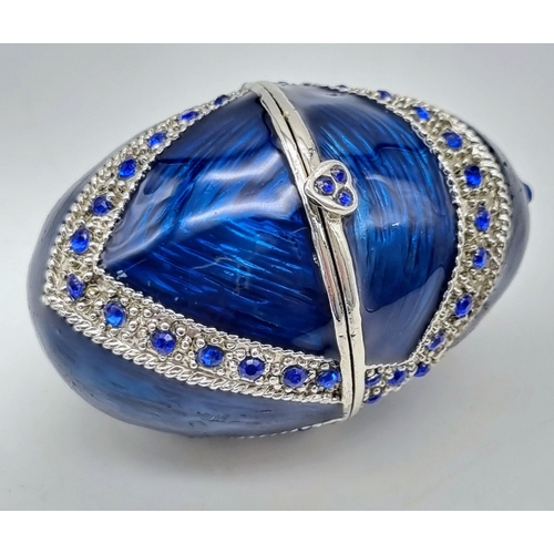 231 - An impressive, Faberge style egg on custom made base with enamel and Swarovski crystals, revealing -... 