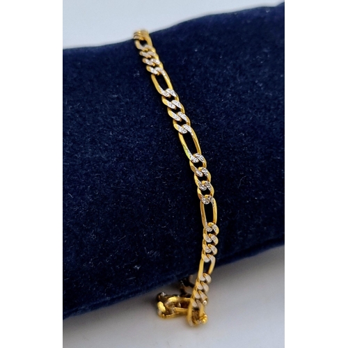 32 - A 9K Yellow and White Gold Figaro Link Bracelet. 24cm. 3.33g total weight.