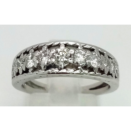 53 - An 18K White Gold and Graduated Diamond Half-Eternity Ring. 11 diamonds - 0.8ct approx. Size M/N. 5.... 