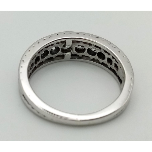 53 - An 18K White Gold and Graduated Diamond Half-Eternity Ring. 11 diamonds - 0.8ct approx. Size M/N. 5.... 