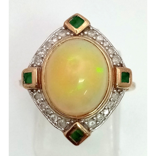 60 - A Vintage 9K Yellow Gold Opal, Emerald and Diamond Ring. Large central fire opal surrounded with eme... 