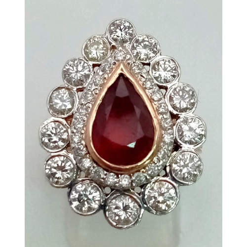 67 - A Gold Plated Silver, Red Stone and Diamond Ring. A central red teardrop stone with two teardrop lay... 