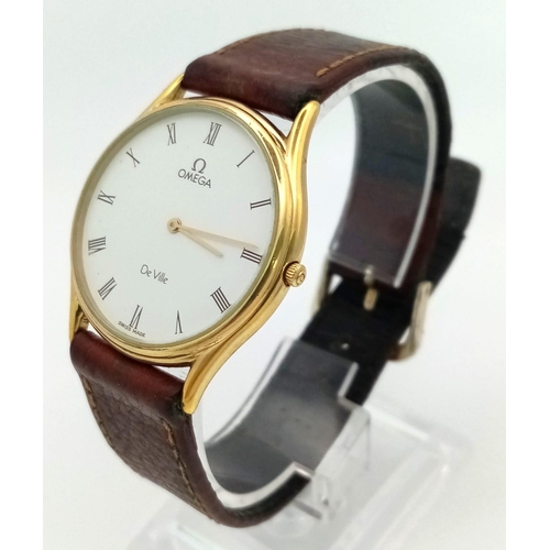 74 - An Omega Deville Quartz Gents Mid-Size watch. Brown leather strap. Two tone case - 30mm. White dial.... 