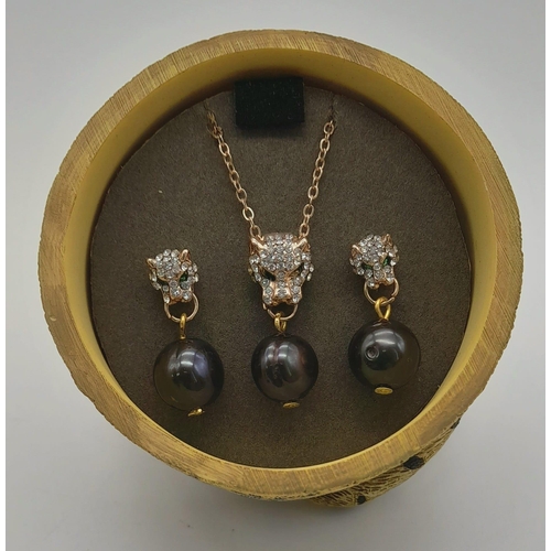 301 - A very elegant panther necklace and matching earrings set with natural, black, Tahitian pearls. Pres... 