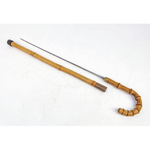 571 - A Vintage Possibly Antique Bamboo with Hidden Sword Walking Stick. Markings on base of blade. Please... 