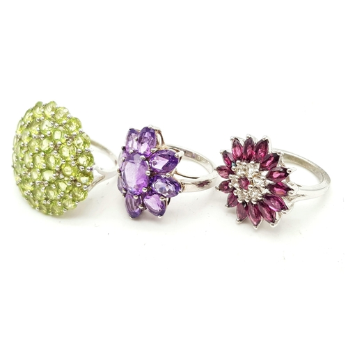 589 - Three 925 Silver Gemstone Rings. Pink topaz, peridot and amethyst floral decorative rings. All size ... 