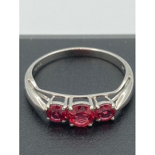 392 - 9k WHITE GOLD and RUBY TRILOGY RING. Full UK hallmark.  Size N.