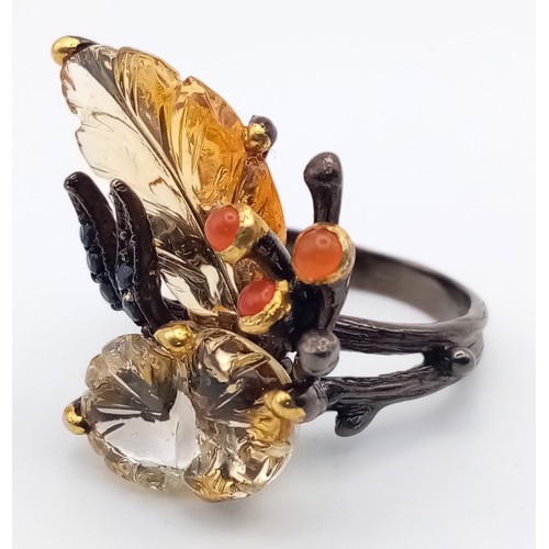 227 - A late Victorian or Edwardian, unique, sterling silver ring with large carved gemstones creating a n... 